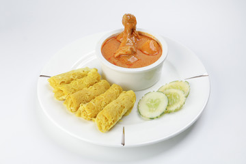 Traditional Malay snack food Roti Jala served with curry chicken with potato on white ceramic plate and bowl
