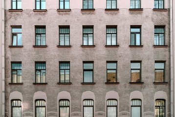 Windows of old buildings in Saint Petersburg, background-symmetry in buildings. 