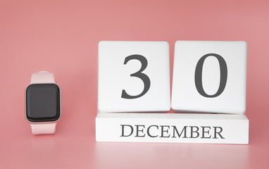 Modern Watch with cube calendar and date 30 december on pink background. Concept winter time vacation.