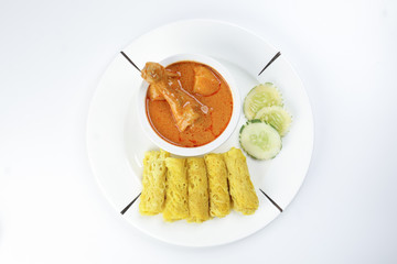 Traditional Malay snack food Roti Jala served with curry chicken with potato on white ceramic plate and bowl