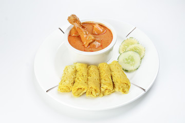 Traditional Malay snack food Roti Jala served with curry chicken with potato on white ceramic plate and bowl