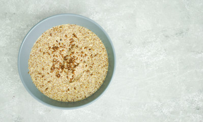 Healthy breakfast on a light background with place for text. 
Flaxseed porridge.