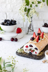 Meringue roll with fresh berries and cream cheese