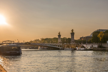 Obraz na płótnie Canvas sunset over seine river in Paris with Grand Palais and Pont Alexandre III bridge in the background 