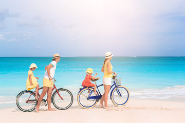 Family with a bike on tropical beach