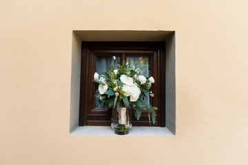 Wedding bouquet in a square window opening.