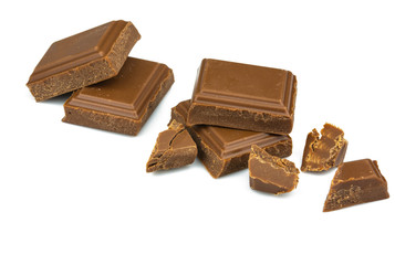 Broken milk chocolate bar on a white background