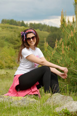 Happy Woman Relaxing in the Summer Mountain with Cloudy Sky