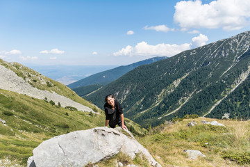 Hiker Woman with Backpack on the Top of a Mountain with Stunning View.Pirin Mountain ,Bulgaria  