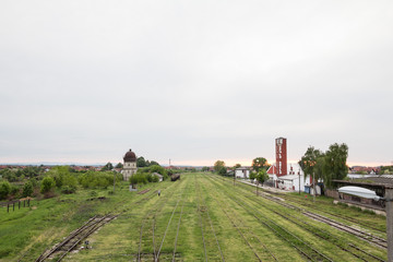 Abandoned train station in Brcko, with the name of the city (Brcko) written in Latin and Cyrillic, with old platforms and rusted rails. it is a city in Bosnia, near the border with Croatia