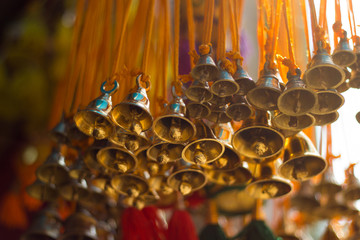 golden christmas decoration bells hanging from yellow threads