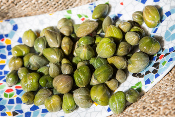 Capers on a plate. Bunch canned pickled or salted capers.