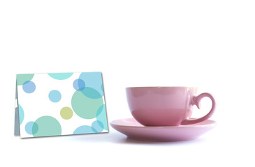 Pink cup of tea on white background with greeting card