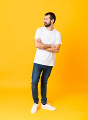 Fototapeta na wymiar Full-length shot of man with beard over isolated yellow background portrait