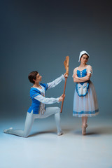 Young and graceful ballet dancers as Cindrella fairytail characters on studio background. Art, motion, action, flexibility, inspiration concept. Flexible caucasian ballet dancers posing, dancing.