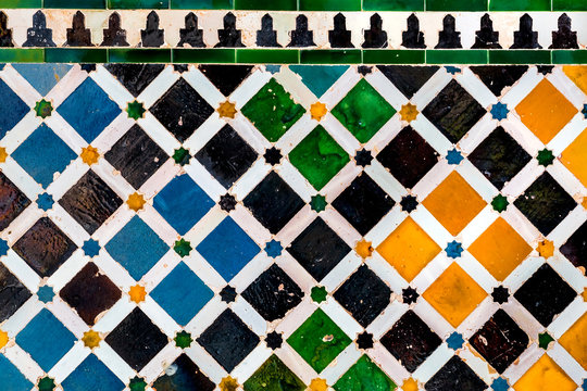 Traditional tiles on patterned wall in Spain. Artistic background.