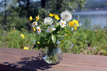 Bouquet of wildflowers in a vase. Sunny summer day.