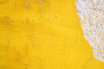Concrete yellow colorful wall surface texture. Abstract grunge bright color background with aging effect. Copyspace.