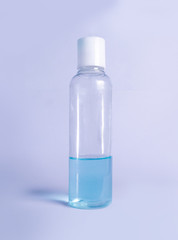 Hand sanitizer liquid, corona virus protection hand sanitizer bottle isolated on sky blue background 
