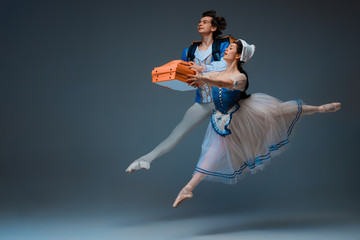 Modern Cinderella and prince hurrying up, deliverying pizza. Young and graceful ballet dancers on...
