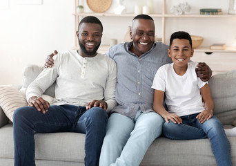 Obraz na płótnie Canvas Cheerful Male Family Members Posing To Camera At Home