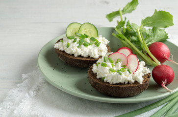 Curd sandwiches with fresh herbs. Fresh rye bread with cottage cheese and green herbs.