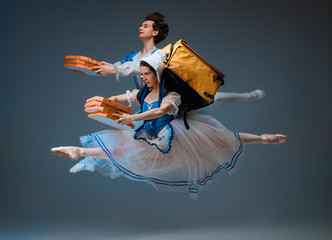 Modern Cinderella and prince hurrying up, deliverying pizza. Young and graceful ballet dancers on...