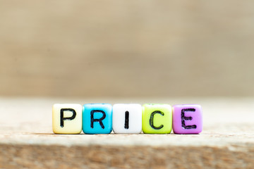 Colorful bead with black letter in word price on wood background