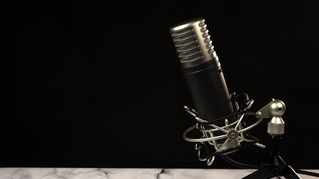 Microphone on black background. Radio, podcast.