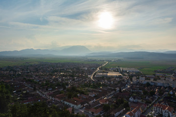 Rasnov Town at sunset. Piatra Craiului mountain on the background. Romania
