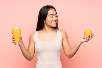 Young Indian woman holding an orange