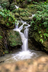 Fototapeta na wymiar A little tropical waterfall in Okinawa, Japan.
