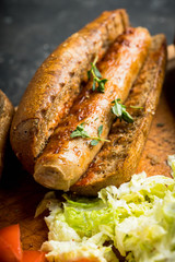 Tasty fresh hot dogs with grilled sausage on the rustic background. Selective focus. Shallow depth of field.