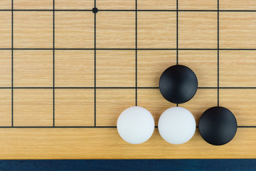 Simple training position of black and white stones on the playing field (gohan) of Chinese game go