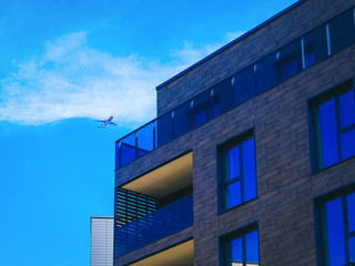 Fototapeta na wymiar Fragment of Modern architecture of residential building and airplane_4x3