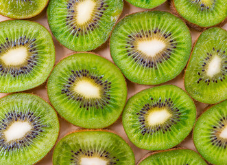 Fresh green kiwifruit background. Flat lay, top view, food concept. Food frame with copy space for your text. Banner. Green kiwi circles texture