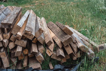 Wooden planks lie on the grass. Wooden beams for construction.