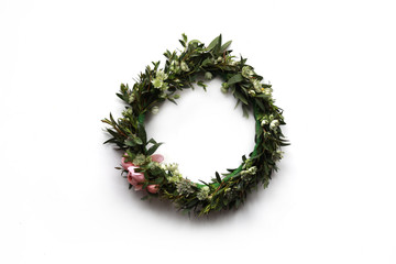 Flower whreath with green leaves and tender pink roses on isolated white background. Top view, flat lay.