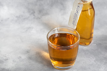 Kombucha or cider, fermented drink on a gray background. A probiotic healthy drink is Kombucha.