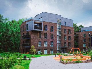 Fototapeta na wymiar Children playground on European modern residential buildings quarter_4x3