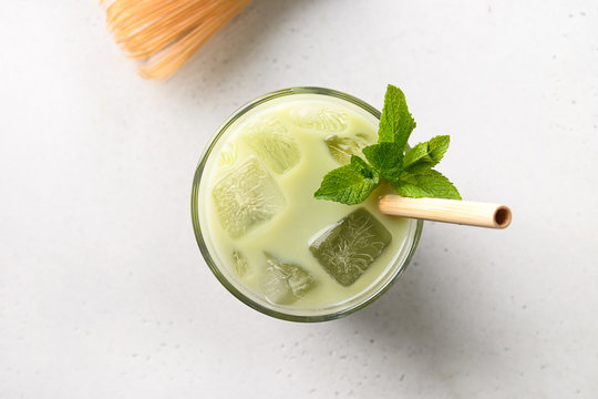 Iced Green Matcha Tea In Glass With Mint Isolated On White. View From Above. Close Up