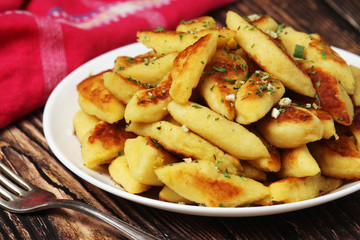 Polish dish kopytka served at the table