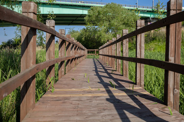 wooden walkways and grasslands on both sides.