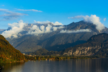 Fototapeta na wymiar Aerial view of cloudy mountains with Brienz lake water down below
