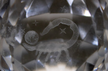Scorpio and stars inside a transparent faceted abstract crystal.