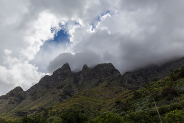 mountainous landscape with lush vegetation on a cloudy and stormy day