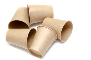 Brown paper cup for coffee, tea, a drink from environmental materials on a white background. A bunch of glasses. Glasses lie on their side in a circle in the form of a ring. Front and top view. Macro