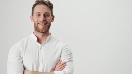Handsome young cheery happy man in white shirt isolated over white wall background - Powered by Adobe