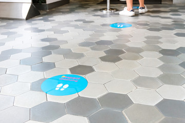 Keep distance sign in front of purchase counter in department store for people to wait in line. New...