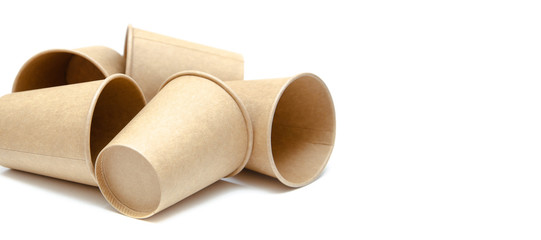 Brown paper cup for coffee, tea, a drink from environmental materials on a white background. A bunch of glasses. Glasses lie on their side in a circle in the form of a ring. Front and top view. Macro